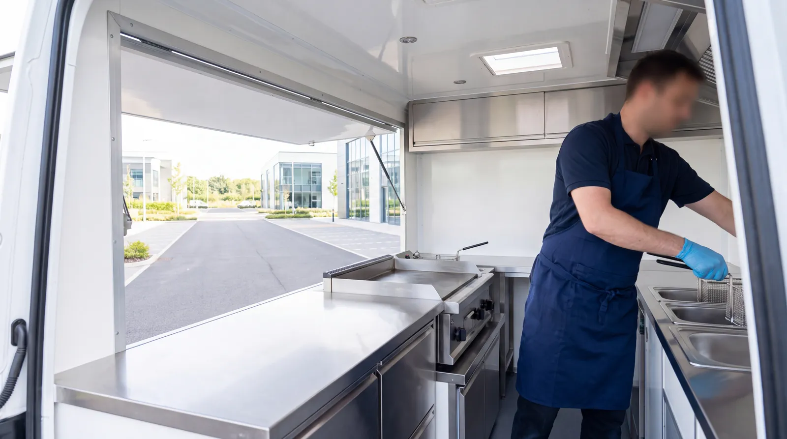 A newly fitted catering conversion with stainless steel prep counters and a griddle